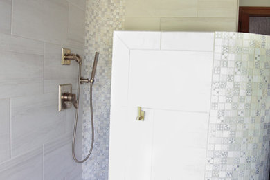 Mid-sized trendy master beige tile and porcelain tile white floor and porcelain tile bathroom photo in Other with recessed-panel cabinets, gray cabinets, a one-piece toilet, white walls and an undermount sink