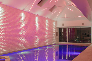 Photo of a contemporary indoor rectangular pool in Surrey.