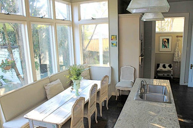 Mid-sized cottage chic single-wall slate floor eat-in kitchen photo in New Orleans with a drop-in sink, granite countertops, stainless steel appliances and an island