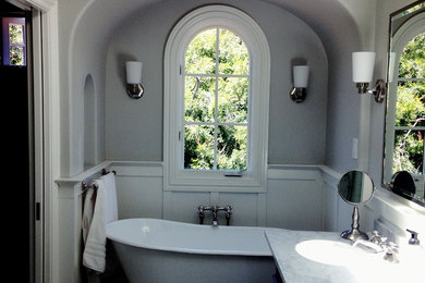 Example of a small classic master porcelain tile and white floor bathroom design in Other with shaker cabinets, dark wood cabinets, a two-piece toilet, white walls, an undermount sink, marble countertops, a hinged shower door and white countertops