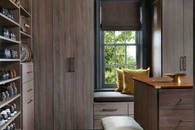 Dressing room - large transitional men's carpeted and gray floor dressing room idea in St Louis with flat-panel cabinets and medium tone wood cabinets