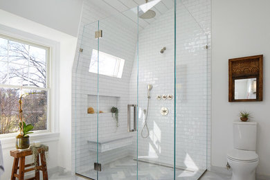 Walk-in shower - large modern master gray tile and subway tile marble floor walk-in shower idea in New York with flat-panel cabinets, gray cabinets, white walls, marble countertops, a two-piece toilet and a vessel sink