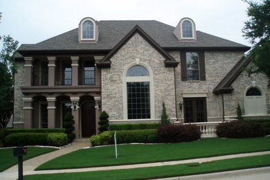 Photo of a large traditional two-storey black exterior in Dallas with a hip roof.