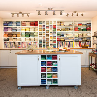 This is an example of a large traditional craft room in Vancouver with beige walls, carpet, a standard fireplace, a freestanding desk and a tile fireplace surround.