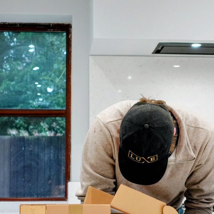 Inspiration for a large transitional single-wall porcelain tile, white floor and coffered ceiling open concept kitchen remodel in Other with a drop-in sink, shaker cabinets, medium tone wood cabinets,