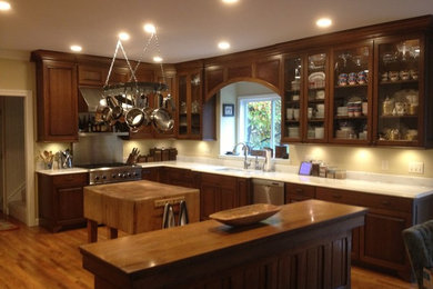 Large traditional kitchen in Other with raised-panel cabinets and multiple islands.