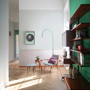 Inspiration for a mid-sized eclectic entry hall in Milan with grey walls, light hardwood floors and beige floor.