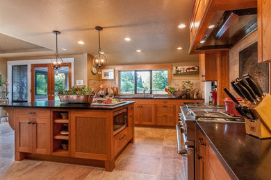 Example of a large transitional porcelain tile and beige floor open concept kitchen design in Seattle with an undermount sink, shaker cabinets, medium tone wood cabinets, solid surface countertops, beige backsplash, stone tile backsplash, stainless steel appliances and an island