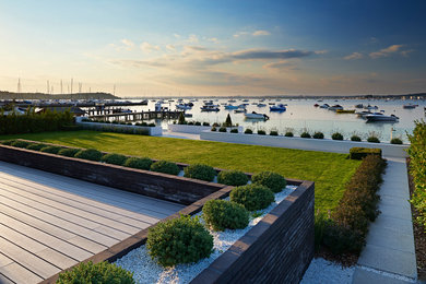 Inspiration for a mid-sized beach style backyard full sun formal garden for summer in Other with natural stone pavers.