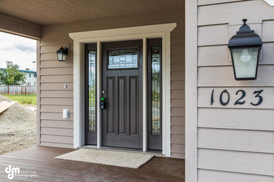 Inspiration for a mid-sized timeless entryway remodel in Other with a black front door and beige walls