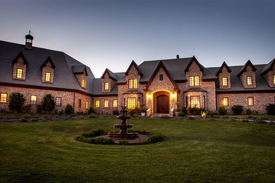 Inspiration for a huge timeless two-story stone exterior home remodel in Los Angeles