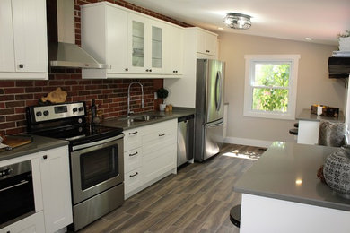 Kitchen - mid-sized industrial galley ceramic tile and multicolored floor kitchen idea in Other with an undermount sink, shaker cabinets, white cabinets, quartzite countertops, red backsplash, brick backsplash, stainless steel appliances and two islands