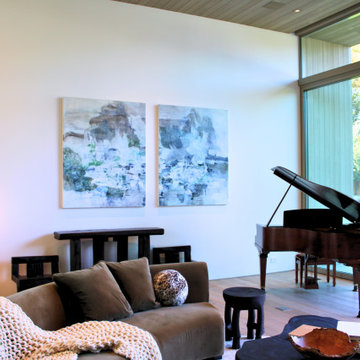 Modern Living Room with Grand Piano and Indoor–Outdoor Views