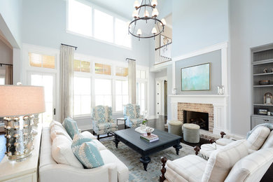 Design ideas for a large transitional open concept living room in Atlanta with grey walls, dark hardwood floors, a standard fireplace, a brick fireplace surround and brown floor.