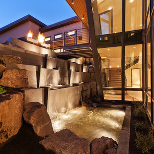 Contemporary courtyard garden in Other with with waterfall.