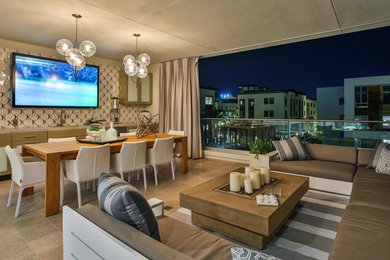 Inspiration for a huge modern stone porch remodel in Los Angeles with a roof extension