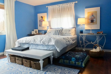 Inspiration for a mid-sized coastal master dark wood floor and brown floor bedroom remodel in Other with blue walls and no fireplace