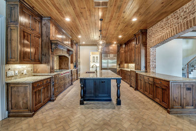 Example of a huge mountain style galley ceramic tile and beige floor eat-in kitchen design in Dallas with a farmhouse sink, recessed-panel cabinets, light wood cabinets, granite countertops, beige backsplash, stone tile backsplash, stainless steel appliances, an island and beige countertops