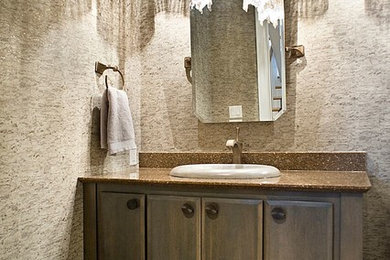 Inspiration for a mid-sized transitional powder room remodel in Other with a two-piece toilet, a drop-in sink and granite countertops