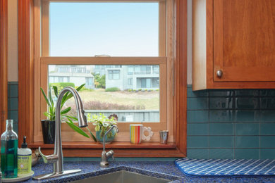 Inspiration for a mid-sized l-shaped medium tone wood floor eat-in kitchen remodel in San Francisco with an undermount sink, medium tone wood cabinets, granite countertops, blue backsplash, ceramic backsplash, stainless steel appliances and blue countertops