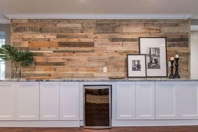 Inspiration for a mid-sized farmhouse single-wall medium tone wood floor open concept kitchen remodel in Philadelphia with shaker cabinets, white cabinets, granite countertops, wood backsplash, stainless steel appliances, no island and multicolored countertops