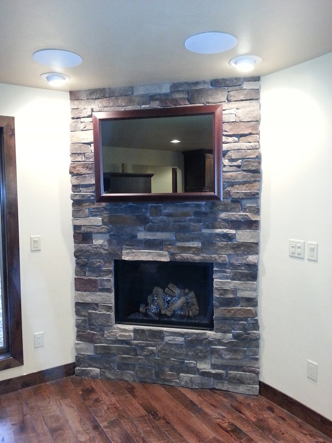 Seura Mirrored TV Installation Above a Stacked Stone Fireplace