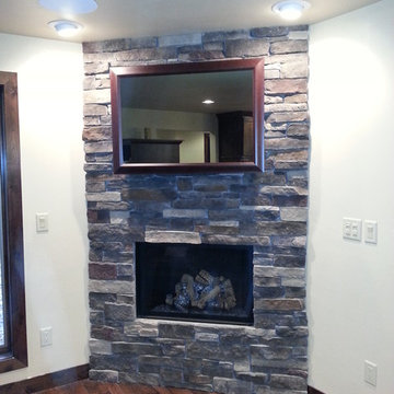 Seura Mirrored TV Installation Above a Stacked Stone Fireplace