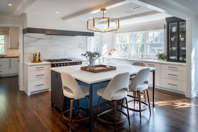 Design ideas for a large contemporary l-shaped kitchen in Minneapolis with an undermount sink, flat-panel cabinets, white cabinets, white splashback, marble splashback, stainless steel appliances, medium hardwood floors, with island, brown floor, white benchtop and exposed beam.