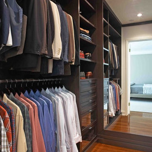 Inspiration for a contemporary men's medium tone wood floor walk-in closet remodel in Los Angeles with open cabinets and dark wood cabinets