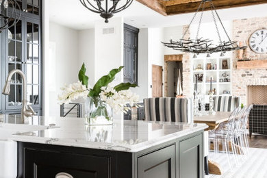 Inspiration for a large country medium tone wood floor, brown floor and wood ceiling eat-in kitchen remodel in Orlando with shaker cabinets, black cabinets, marble countertops, an island and gray countertops