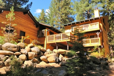 Example of a large mountain style brown three-story wood exterior home design in San Francisco with a shingle roof