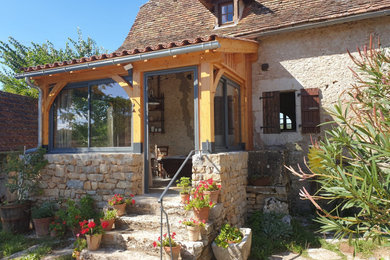 Inspiration pour une véranda rustique.