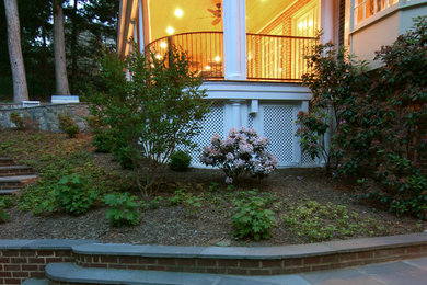 Large classic screened-in back porch idea in DC Metro with decking and a roof extension