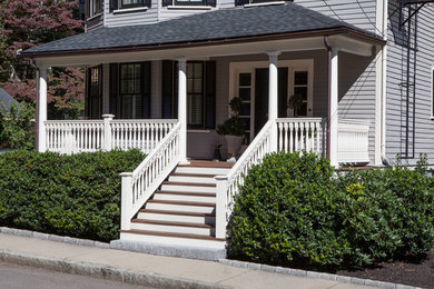 Photo of a large traditional front yard verandah in Boston with decking and a roof extension.