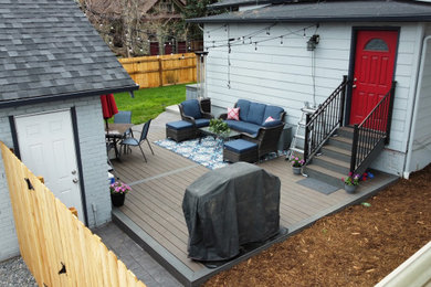 Example of a mid-sized trendy backyard ground level metal railing deck design in Denver