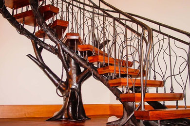 Example of a large trendy wooden u-shaped metal railing staircase design in Boston with wooden risers