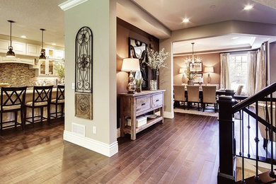 Example of a large classic single-wall medium tone wood floor and brown floor eat-in kitchen design in Minneapolis with white cabinets, granite countertops, brown backsplash, mosaic tile backsplash and an island