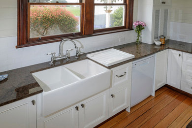 This is an example of a traditional kitchen in Hobart with a double-bowl sink and medium hardwood floors.