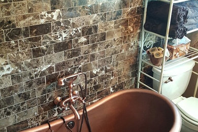 Inspiration for a mid-sized mediterranean master beige tile, brown tile and porcelain tile ceramic tile freestanding bathtub remodel in Philadelphia with raised-panel cabinets, dark wood cabinets, a two-piece toilet, brown walls, an undermount sink and granite countertops
