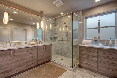 Design ideas for a large modern master bathroom in Seattle with flat-panel cabinets, light wood cabinets, a corner shower, gray tile, stone tile, beige walls, marble floors, an undermount sink, marble benchtops, grey floor and a hinged shower door.