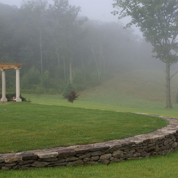Pergola and stone wall