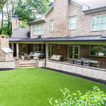 Luxury Covered Backyard Patio with Outdoor Fireplace and Lounge Seating