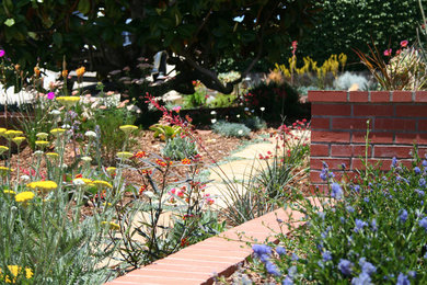 Design ideas for a front yard partial sun garden in San Diego with a garden path and natural stone pavers.
