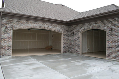 Mid-sized attached three-car garage photo in Salt Lake City