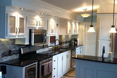 Example of a small classic galley ceramic tile and beige floor kitchen design in New York with white cabinets, granite countertops, brown backsplash, an island and black countertops