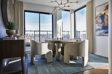 Dining room - contemporary medium tone wood floor and brown floor dining room idea in Toronto with white walls