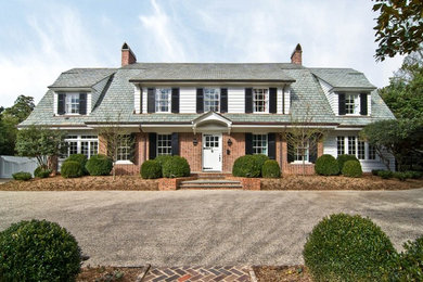 Inspiration for a mid-sized timeless multicolored two-story mixed siding house exterior remodel in Charlotte with a hip roof and a shingle roof