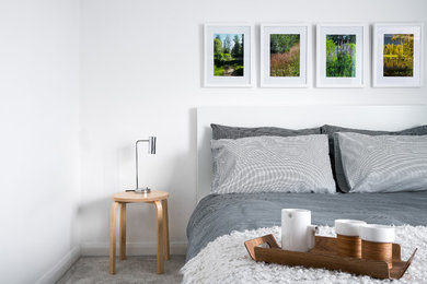Scandinavian guest bedroom in Cambridgeshire with white walls.