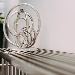 Design ideas for a large modern home office and library in Edmonton with grey walls, ceramic flooring and a hanging fireplace.