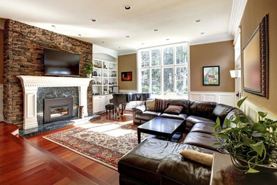 Family room - mid-sized contemporary enclosed dark wood floor and brown floor family room idea in DC Metro with beige walls, a standard fireplace, a stone fireplace and a wall-mounted tv
